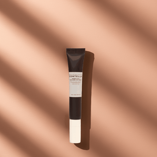 Crema contorno occhi Madagascar Centella in tubetto marrone scuro e beige, con tappo bianco e confezione essenziale