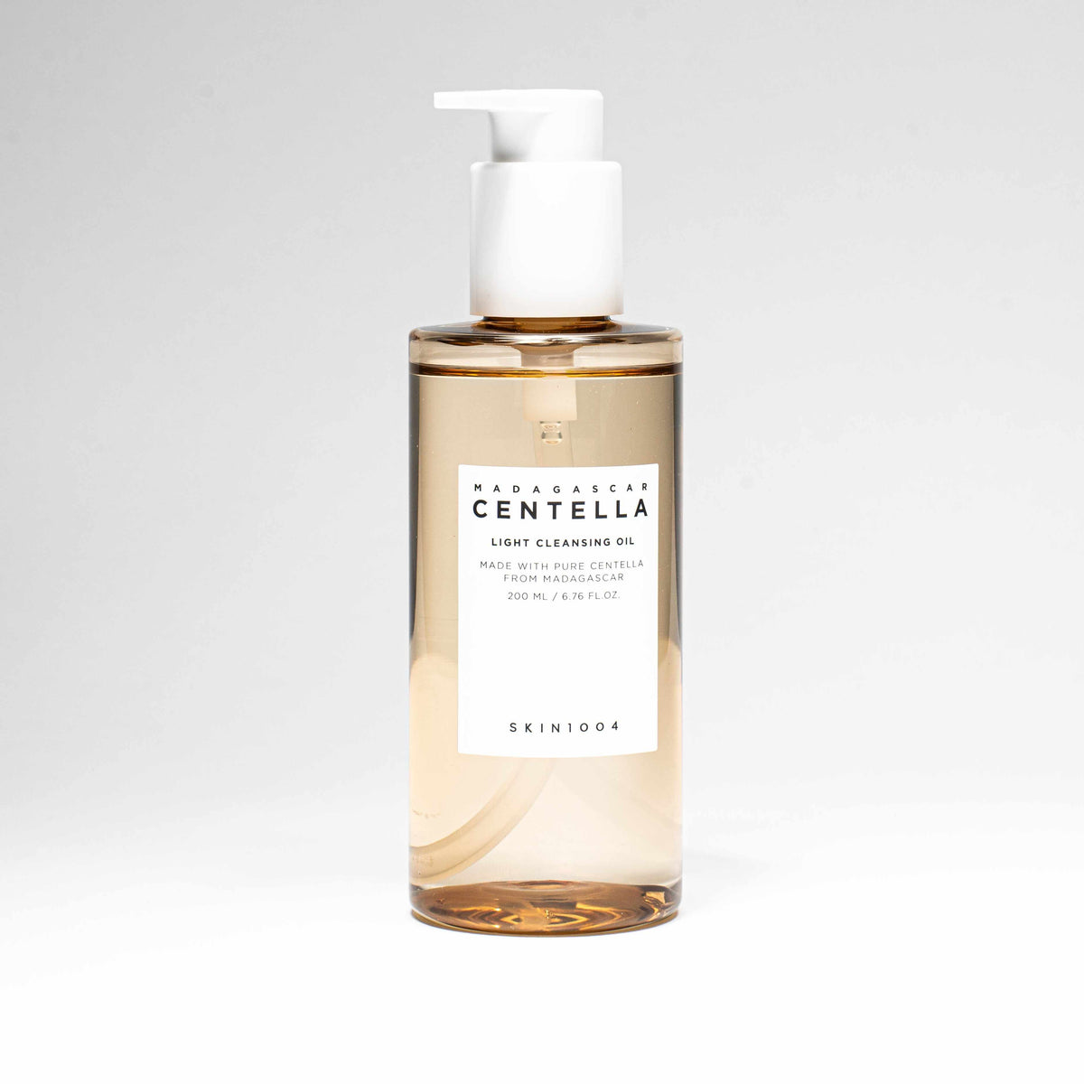 Olio detergente Madagascar centella light cleansing oil in flacone trasparente ambrato, con etichetta bianca e pompetta bianca.