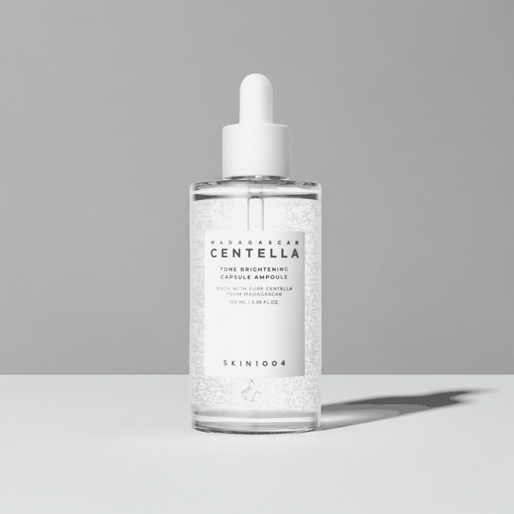 Ampolla viso Tonico Brightening trasparente in vetro con contagocce bianco e formula con capsule visibili